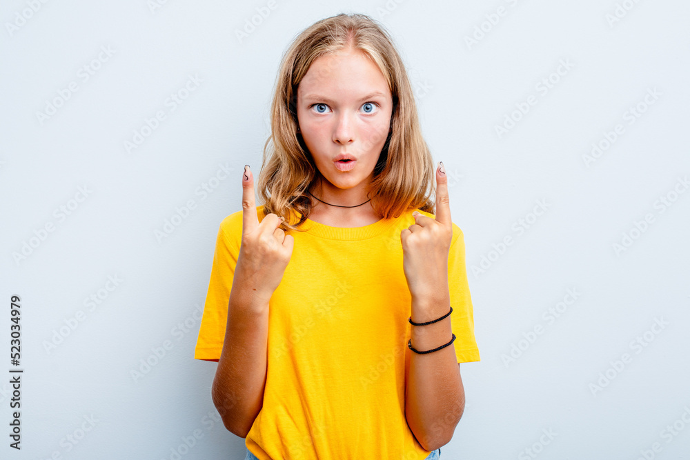 Caucasian teen girl isolated on blue background pointing upside with opened mouth. Caucasian teen girl isolated on blue background pointing upside with opened mouth.