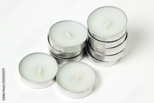 Tea candles on a white background. Set of tea lights.