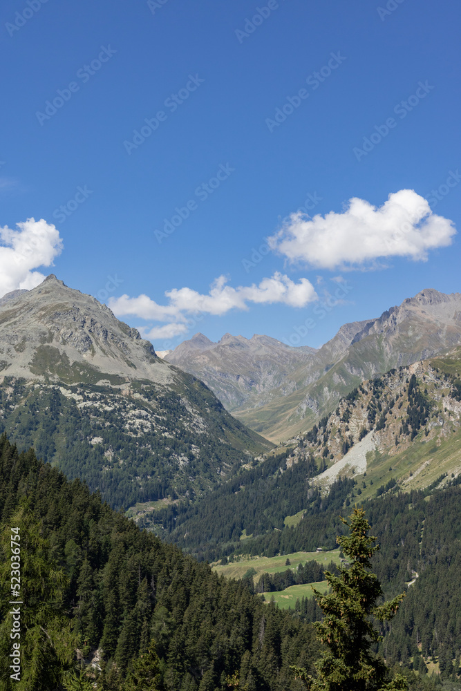 Swiss mountains and lakes on a sunny day with white clouds