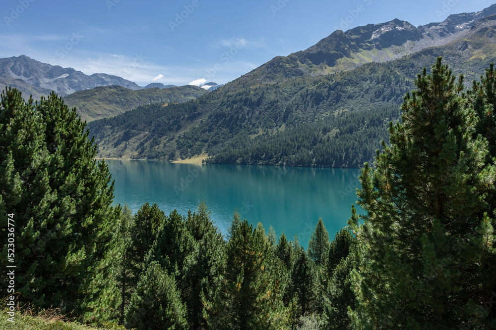 Swiss mountains and lakes on a sunny day with white clouds