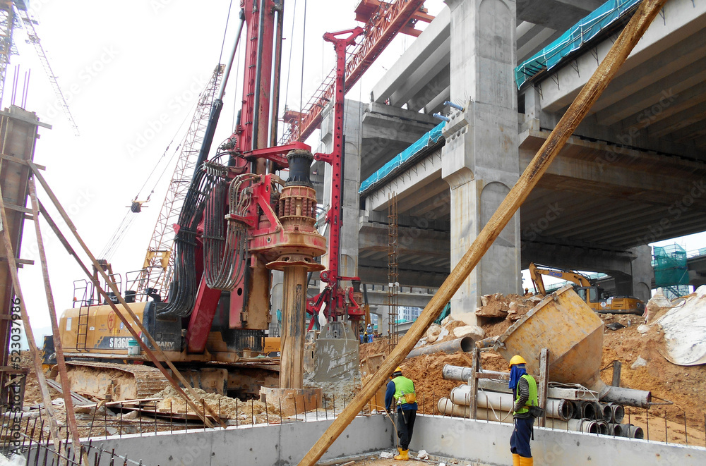KUALA LUMPUR, MALAYSIA -MARCH 30, 2022: Bore pile rig machine at the construction site. The machine used to driven pile for building foundation work. Operated by skilled workers. KUALA LUMPUR, MALAYSIA -MARCH 30, 2022: Bore pile rig machine at the construction site. The machine used to driven pile for building foundation work. Operated by skilled workers.
