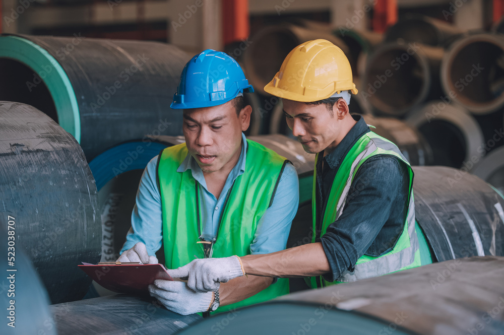 Asian engineer factory manager and mechanic worker employee in safety hard hat talking and inspection inside the factory Asian engineer factory manager and mechanic worker employee in safety hard hat talking and inspection inside the factory