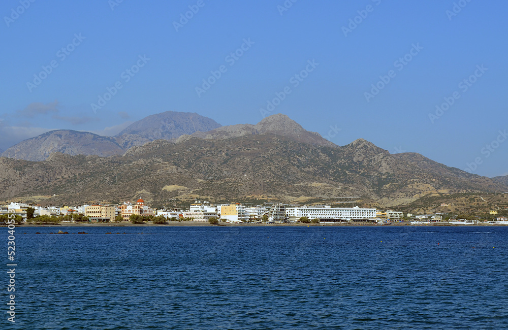 Cozy city Ierapetra on the Libyan sea coat against the background of distant mountains. Crete island, Greece.