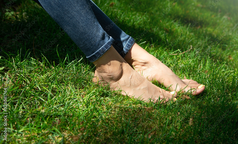 Woman legs relax feeling on green grass background. Woman legs relax feeling on green grass background.