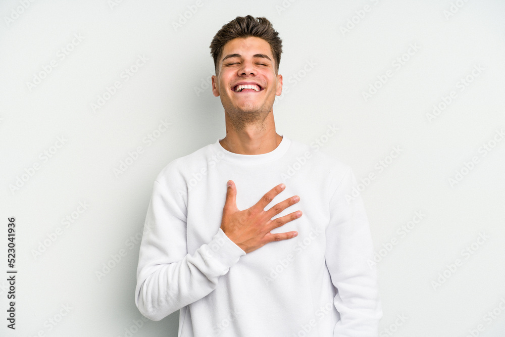 Young caucasian man isolated on white background laughs out loudly keeping hand on chest. Young caucasian man isolated on white background laughs out loudly keeping hand on chest.