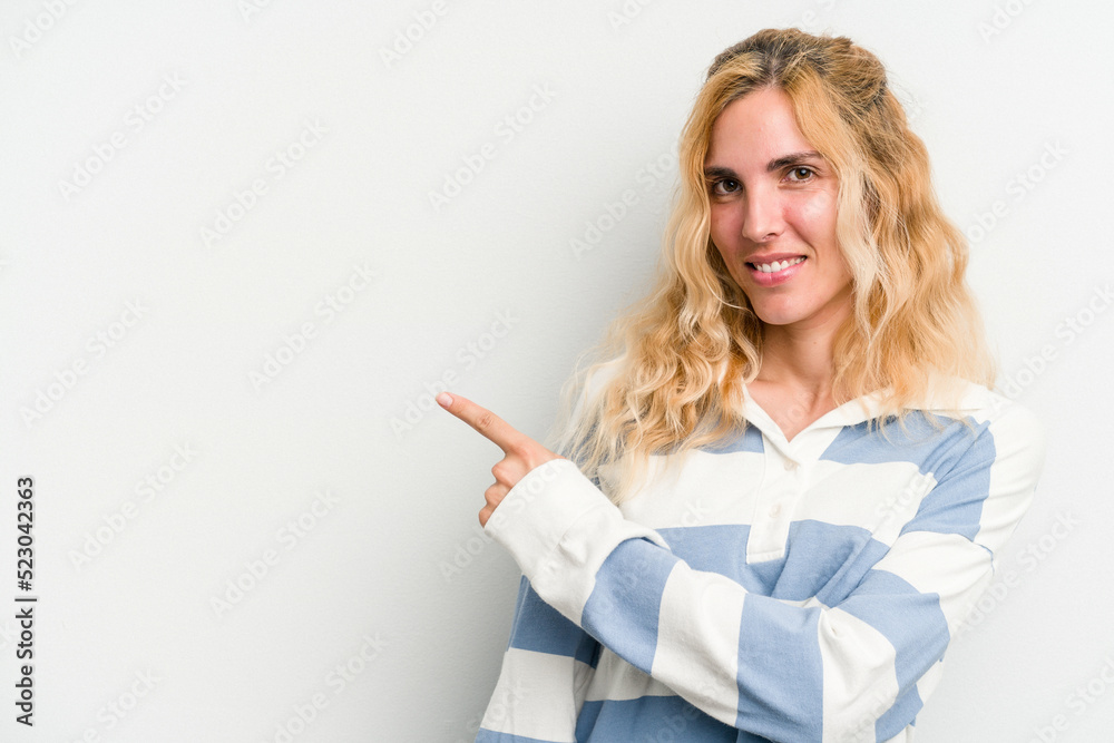 Young caucasian woman isolated on white background smiling and pointing aside, showing something at blank space. Young caucasian woman isolated on white background smiling and pointing aside, showing something at blank space.