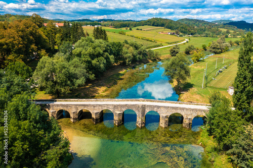 Aerial view of the old stone bridge on the Dobra River, Croatia