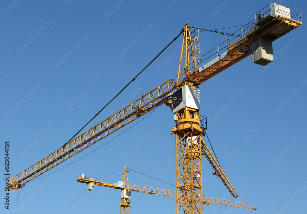 A boom cranes in the blue sky