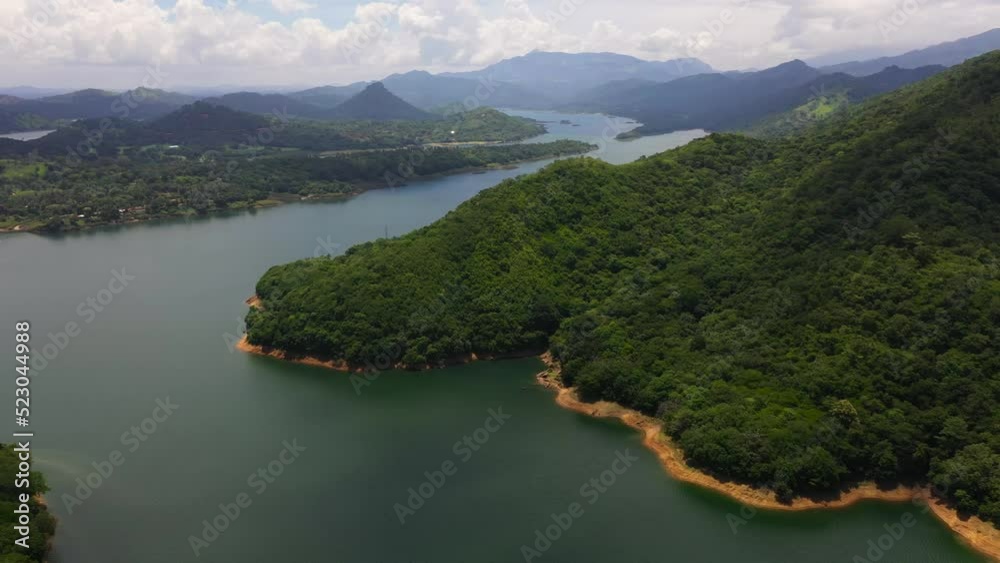 Aerial view of Lake among the mountains covered with green forest and jungle. Victoria Reservoir, Sri Lanka. Aerial view of Lake among the mountains covered with green forest and jungle. Victoria Reservoir, Sri Lanka.