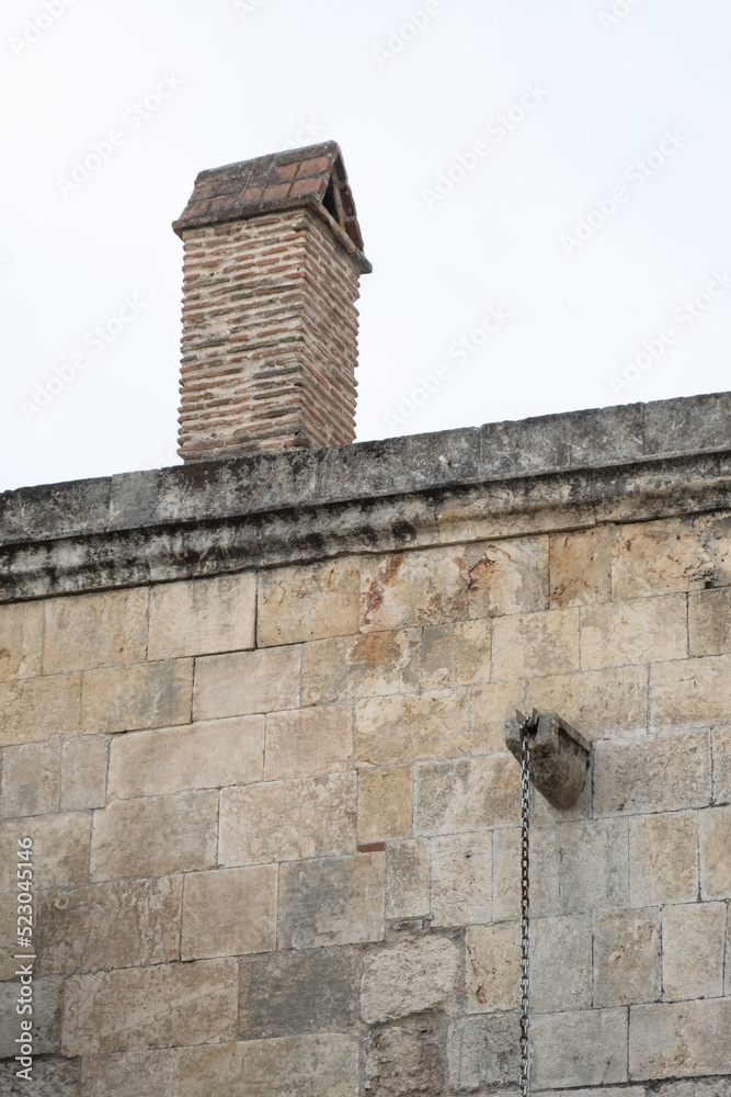 brick chimney on historical stone building roof brick chimney on historical stone building roof