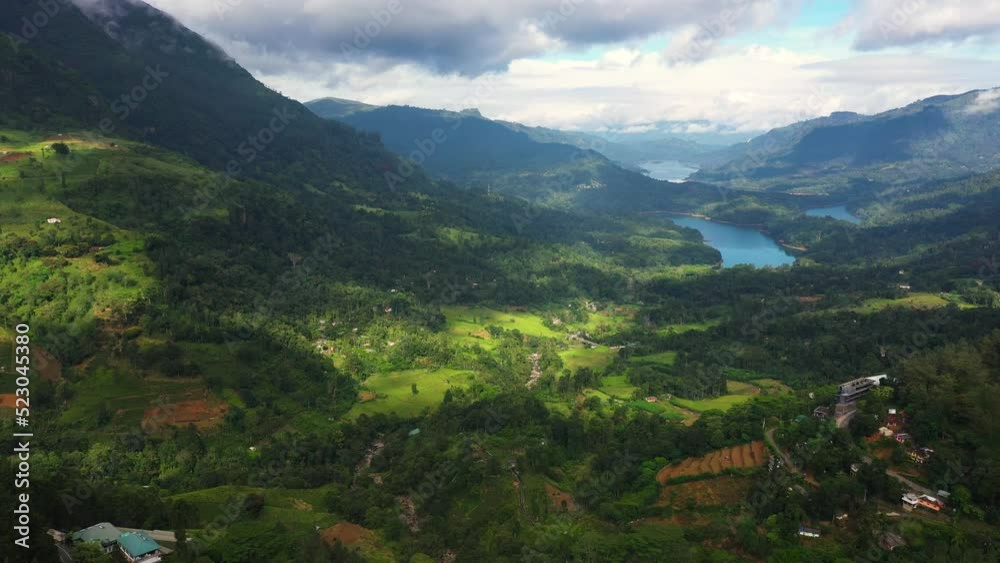 Aerial view of Mountain valley with the lakes among tea plantations and mountains. Kotmale Reservoir. Ramboda, Sri Lanka. Aerial view of Mountain valley with the lakes among tea plantations and mountains. Kotmale Reservoir. Ramboda, Sri Lanka.