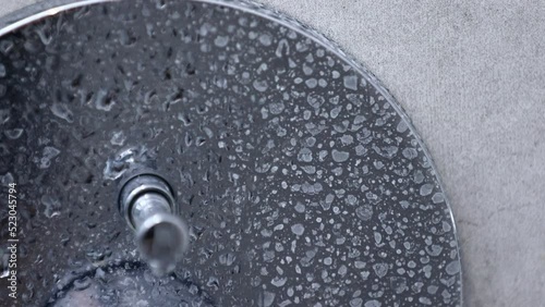Detail of dirty calcified chrome shower mixer tap, faucet with limescale or lime scale on it. Lime deposits on plumbing, the concept of choice of detergents for cleaning, careful care of plumbing.