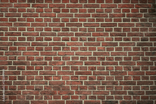 Brick wall background. Pattern brown color design decorative uneven cracked real stone wall surface with cement. Dry brick wall as seamless background