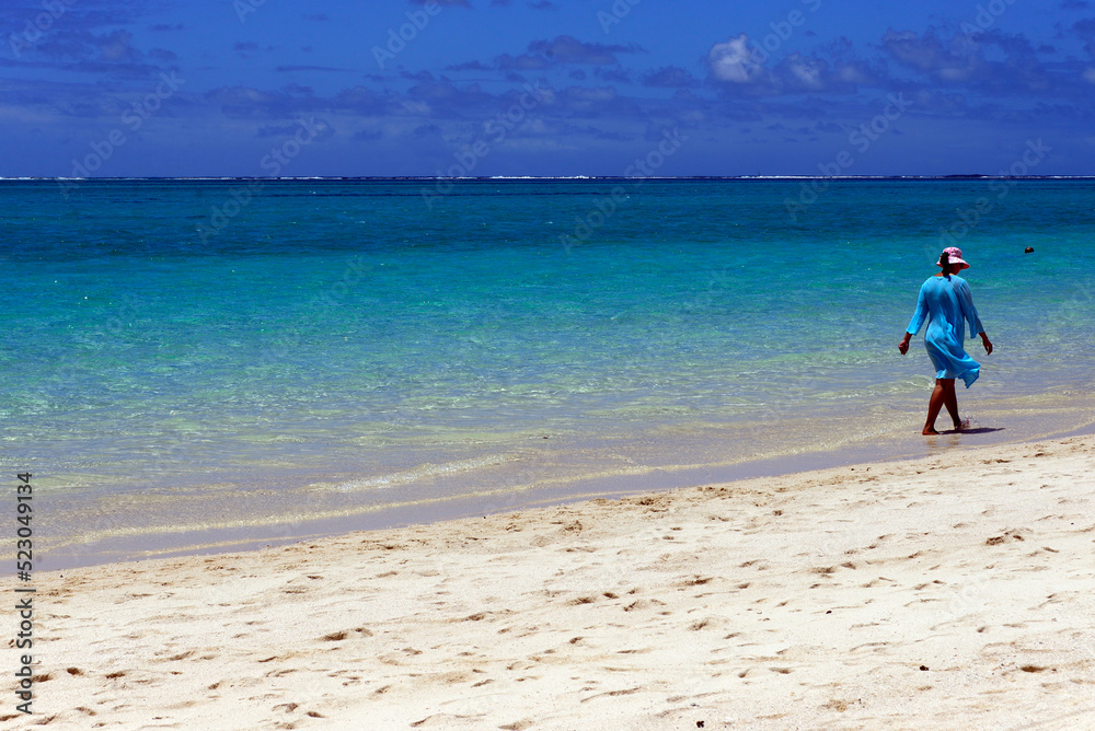 single woman walking at the seaside, Pointe d'Esny beach, Grand Port District,  Southeastern coast of Mauritius, Africa