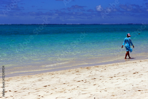 single woman walking at the seaside, Pointe d'Esny beach, Grand Port District,  Southeastern coast of Mauritius, Africa