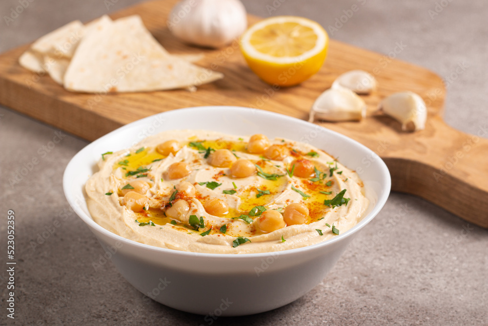 Delicious hummus with chickpeas, olive oil, lemon and pita bread. Vegetarian food concept. 