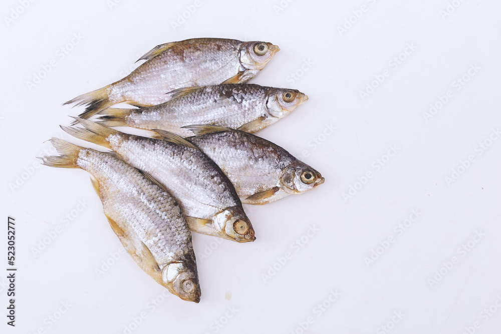isolated closeup top view dried salted roach fish on white background isolated closeup top view dried salted roach fish on white background