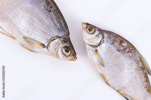 isolated closeup top view dried salted roach fish on white background photo