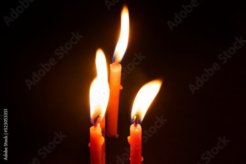 Close-Up Of Burning Candles Against Black Background during diwali festival