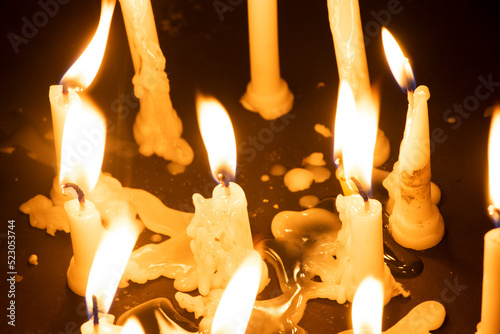 Photography Close-Up Of Burning Candles Against Black Background during diwali festival