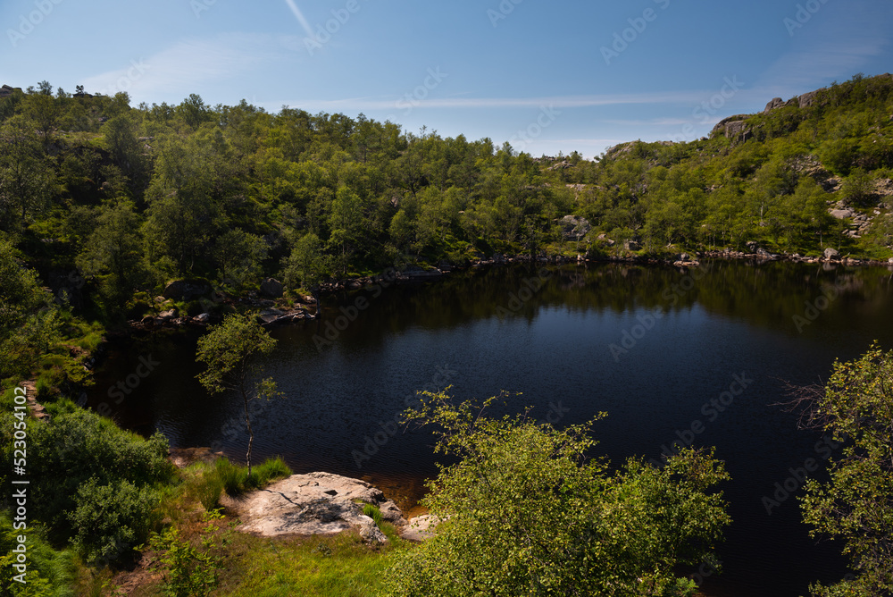 Clear mirror-like mountain lake in the area around Pulpit Rock (Preikestolen), Savanger, Norway Clear mirror-like mountain lake in the area around Pulpit Rock (Preikestolen), Savanger, Norway