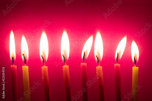 Burning Candles Against Color Background during diwali festival