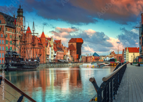 Old town in Gdansk with historical port crane over Motlawa river at sunrise, Poland.