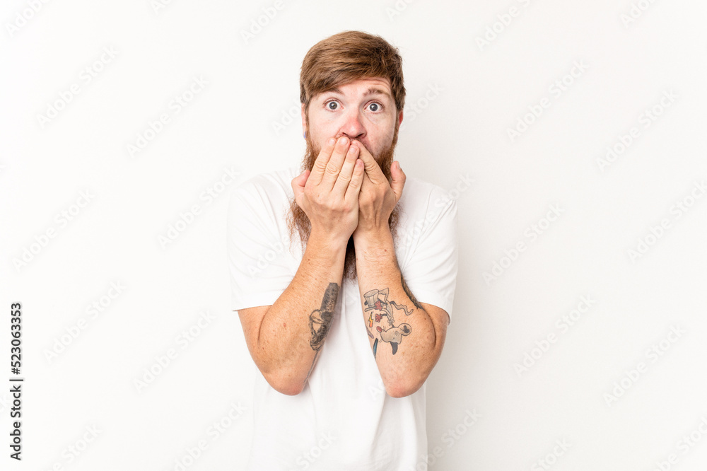 Young caucasian red-haired man isolated on white background shocked, covering mouth with hands, anxious to discover something new. Young caucasian red-haired man isolated on white background shocked, covering mouth with hands, anxious to discover something new.