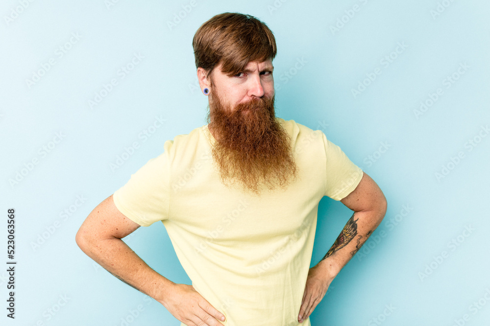 Young caucasian red-haired man isolated on blue background confused, feels doubtful and unsure. Young caucasian red-haired man isolated on blue background confused, feels doubtful and unsure.
