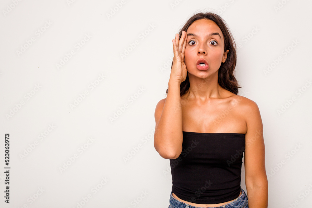 Young hispanic woman isolated on white background shouts loud, keeps eyes opened and hands tense. Young hispanic woman isolated on white background shouts loud, keeps eyes opened and hands tense.