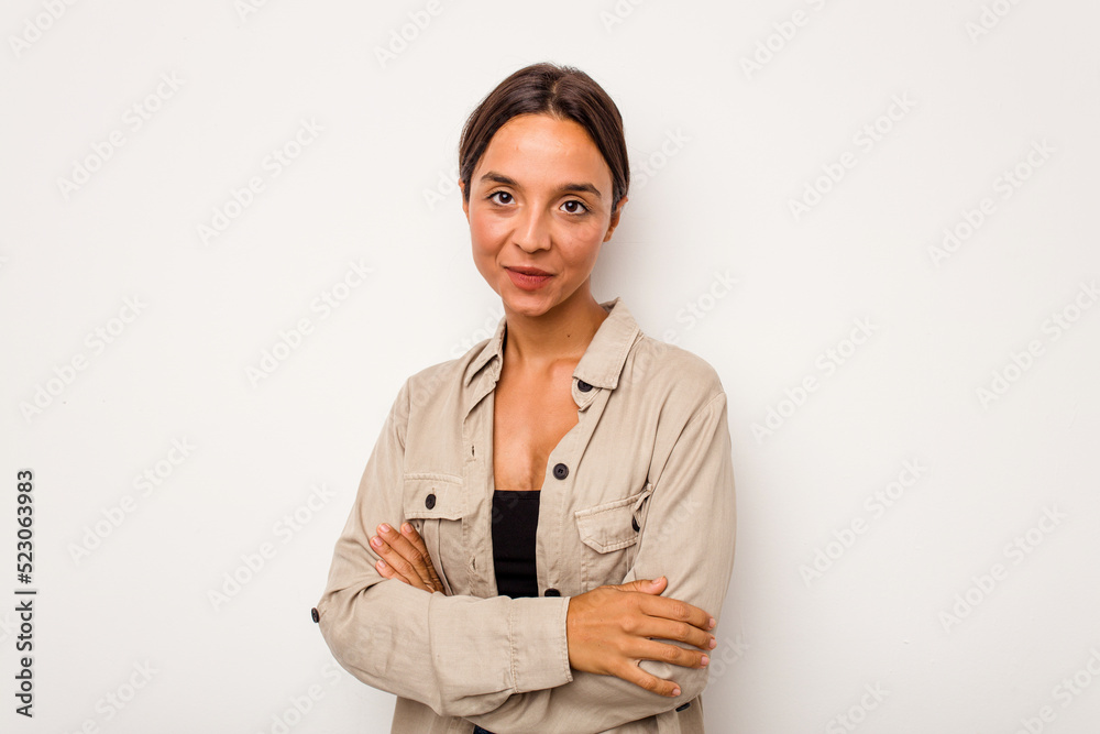 Young hispanic woman isolated on white background who feels confident, crossing arms with determination. Young hispanic woman isolated on white background who feels confident, crossing arms with determination.