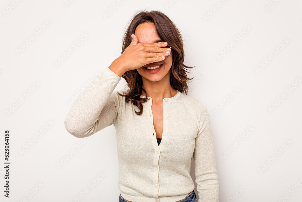 Young hispanic woman isolated on white background covers eyes with hands, smiles broadly waiting for a surprise. Young hispanic woman isolated on white background covers eyes with hands, smiles broadly waiting for a surprise.