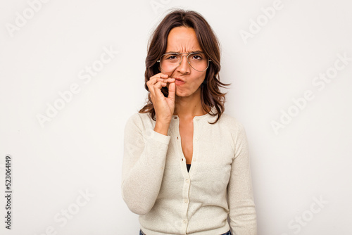 Young hispanic woman isolated on white background with fingers on lips keeping a secret.