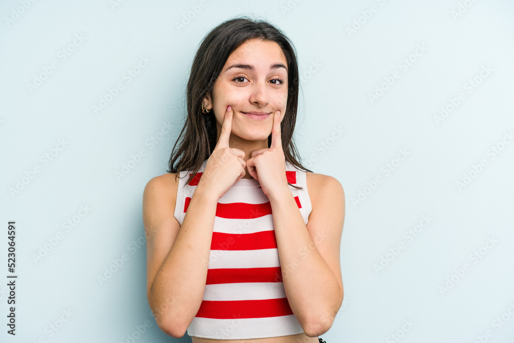 Young caucasian woman isolated on blue background doubting between two options. Young caucasian woman isolated on blue background doubting between two options.