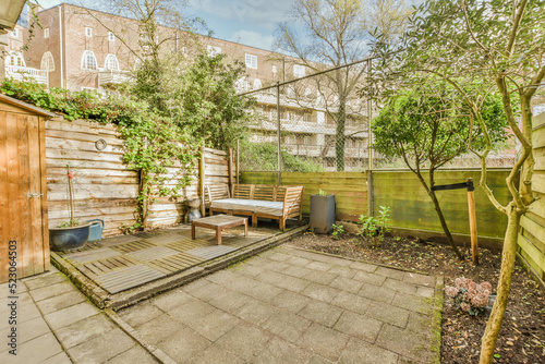 Simple small empty patio with snear wooden fence photo