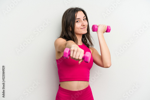 Young caucasian woman holding dumbbells isolated on white background