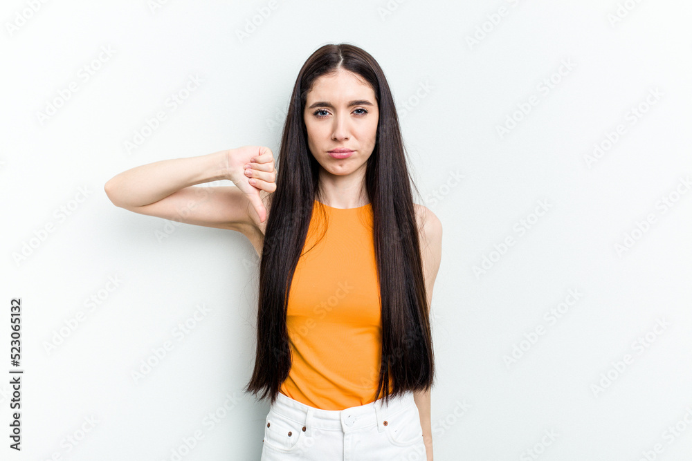 Young caucasian woman isolated on white background showing thumb down, disappointment concept. Young caucasian woman isolated on white background showing thumb down, disappointment concept.