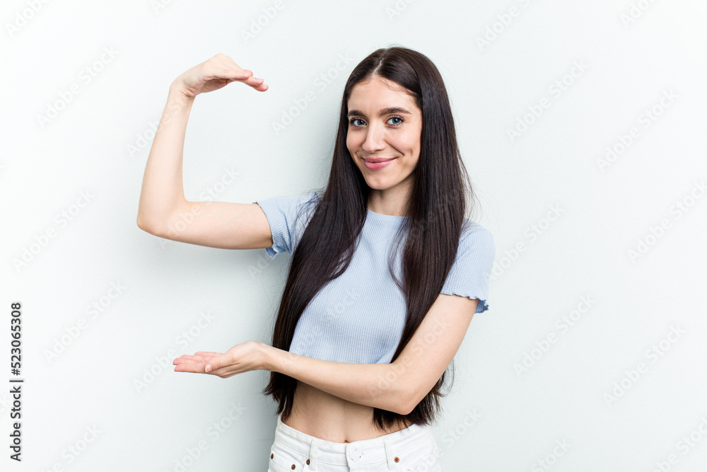 Young caucasian woman isolated on white background holding something little with forefingers, smiling and confident. Young caucasian woman isolated on white background holding something little with forefingers, smiling and confident.