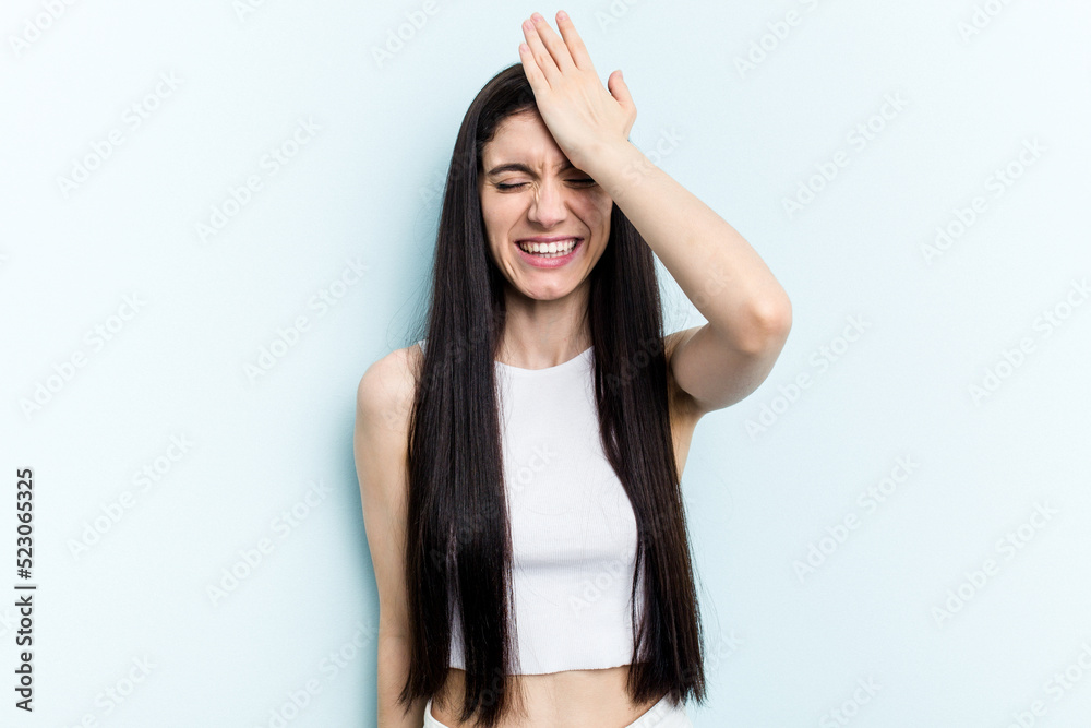Young caucasian woman isolated on blue background forgetting something, slapping forehead with palm and closing eyes. Young caucasian woman isolated on blue background forgetting something, slapping forehead with palm and closing eyes.