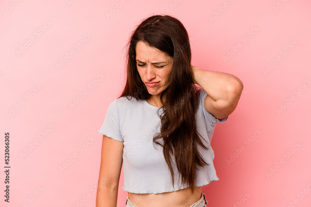 Young caucasian woman isolated on pink background suffering neck pain due to sedentary lifestyle. Young caucasian woman isolated on pink background suffering neck pain due to sedentary lifestyle.