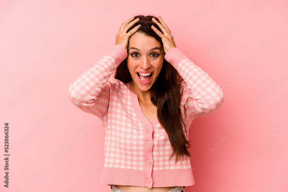 Young caucasian woman isolated on pink background screaming, very excited, passionate, satisfied with something. Young caucasian woman isolated on pink background screaming, very excited, passionate, satisfied with something.