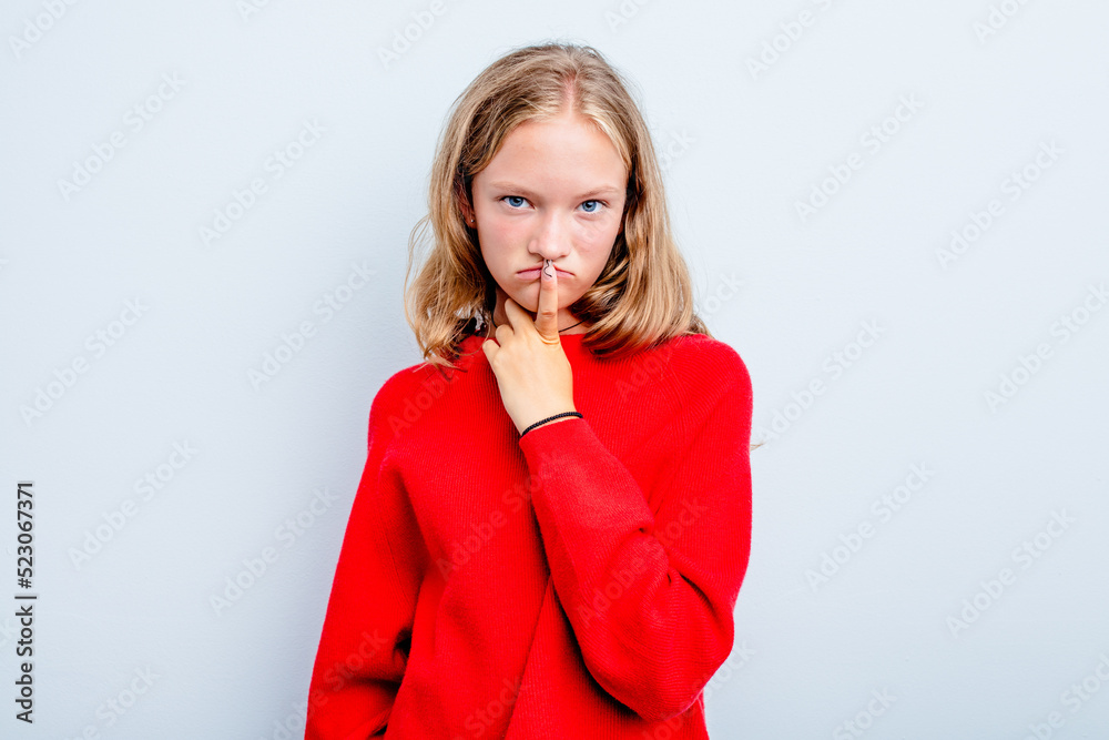Caucasian teen girl isolated on blue background thinking and looking up, being reflective, contemplating, having a fantasy. Caucasian teen girl isolated on blue background thinking and looking up, being reflective, contemplating, having a fantasy.