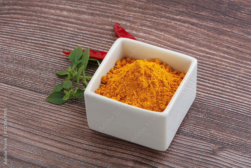 Yellow vibrant curcuma powder in the bowl Yellow vibrant curcuma powder in the bowl