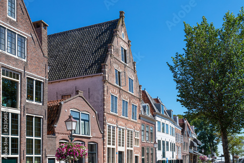 Row of canal houses along a canal in the dutch historic city of Hoorn.
