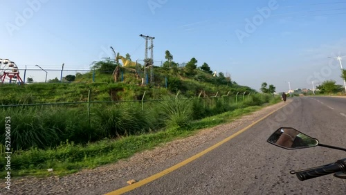 Park view from moving bike camera, Go Pro video shot, traveling on road on motorcycle, Pakistan or India or South Asia photo