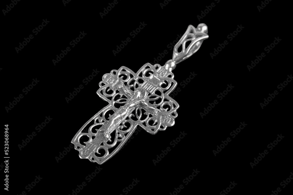 Fototapeta premium Silver crucifix necklace cross isolated on black background