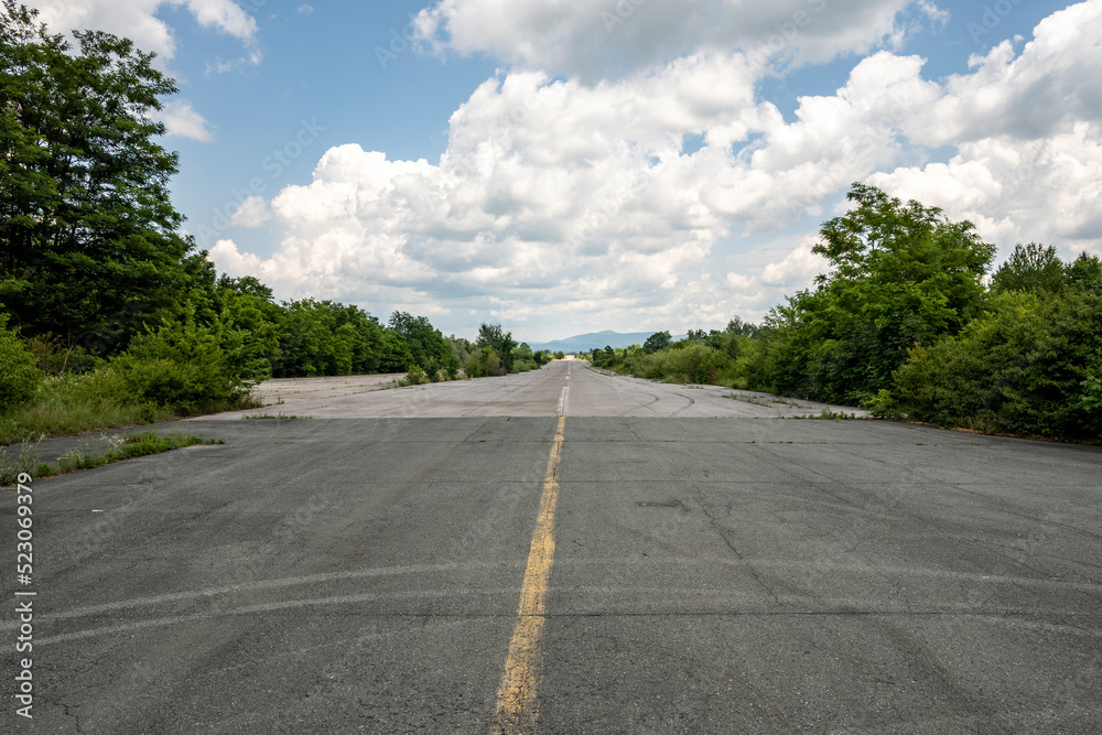 Long, aeroplane runway at the forsaken and abandoned Zeljava military airbase, Croatia, now popular tourist destination for bikers and adventure seekers