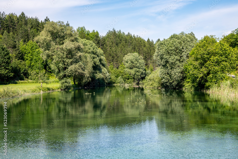 Fototapeta premium Beautiful, turquoise coloured Korana river, flowing through the green forests of Lika, mountain region of Croatia near famous Plitvice lakes