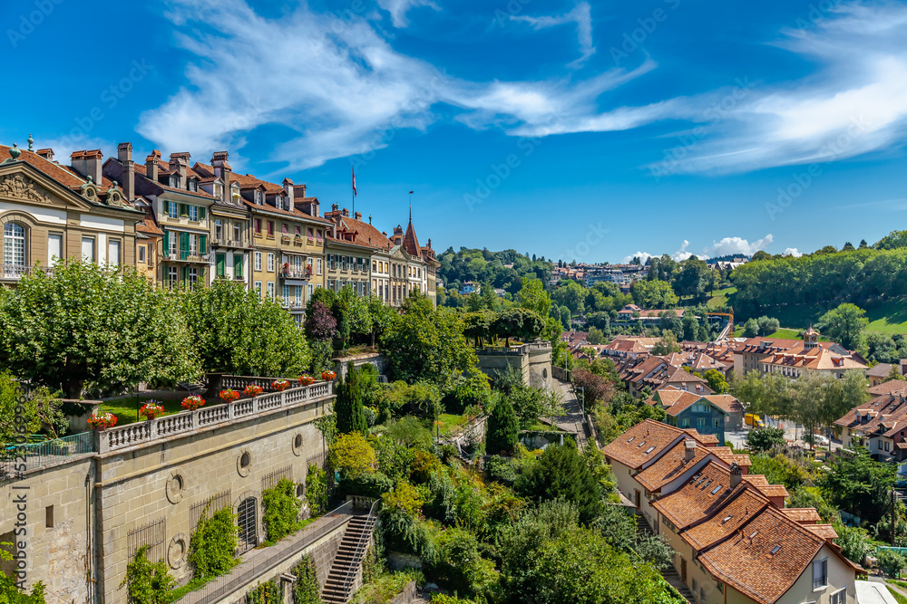 Green terraces in the front of the historic residential houses built along the riverbank of River Aare in Bern, Switzerland.