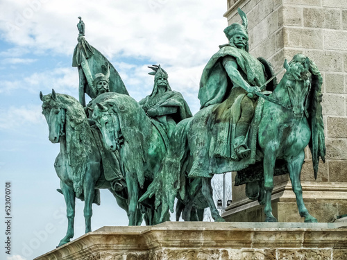 Budapest. 
The equestrian statues depict chieftains who conquered the Pannonian Plain under the leadership of Prince Árpád. The statues symbolize War, Peace, Work and Prosperity, Knowledge and Glory.
 photo